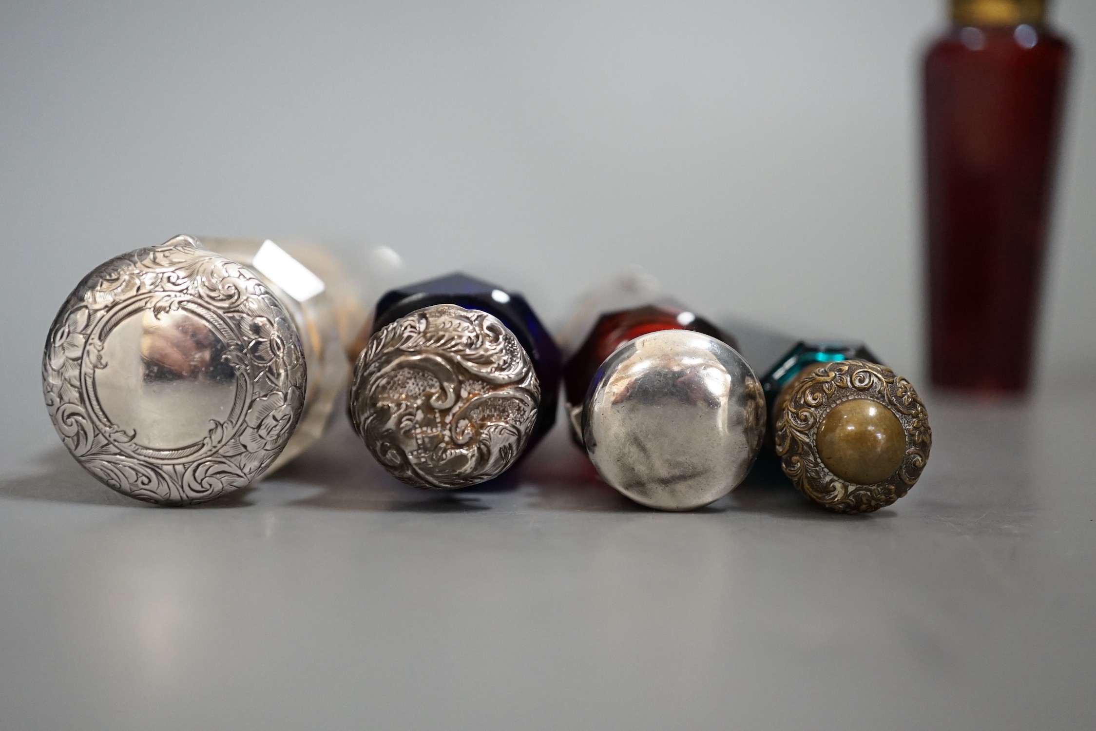 A collection of 19th century coloured and clear glass scent bottles, some silver mounted (6)